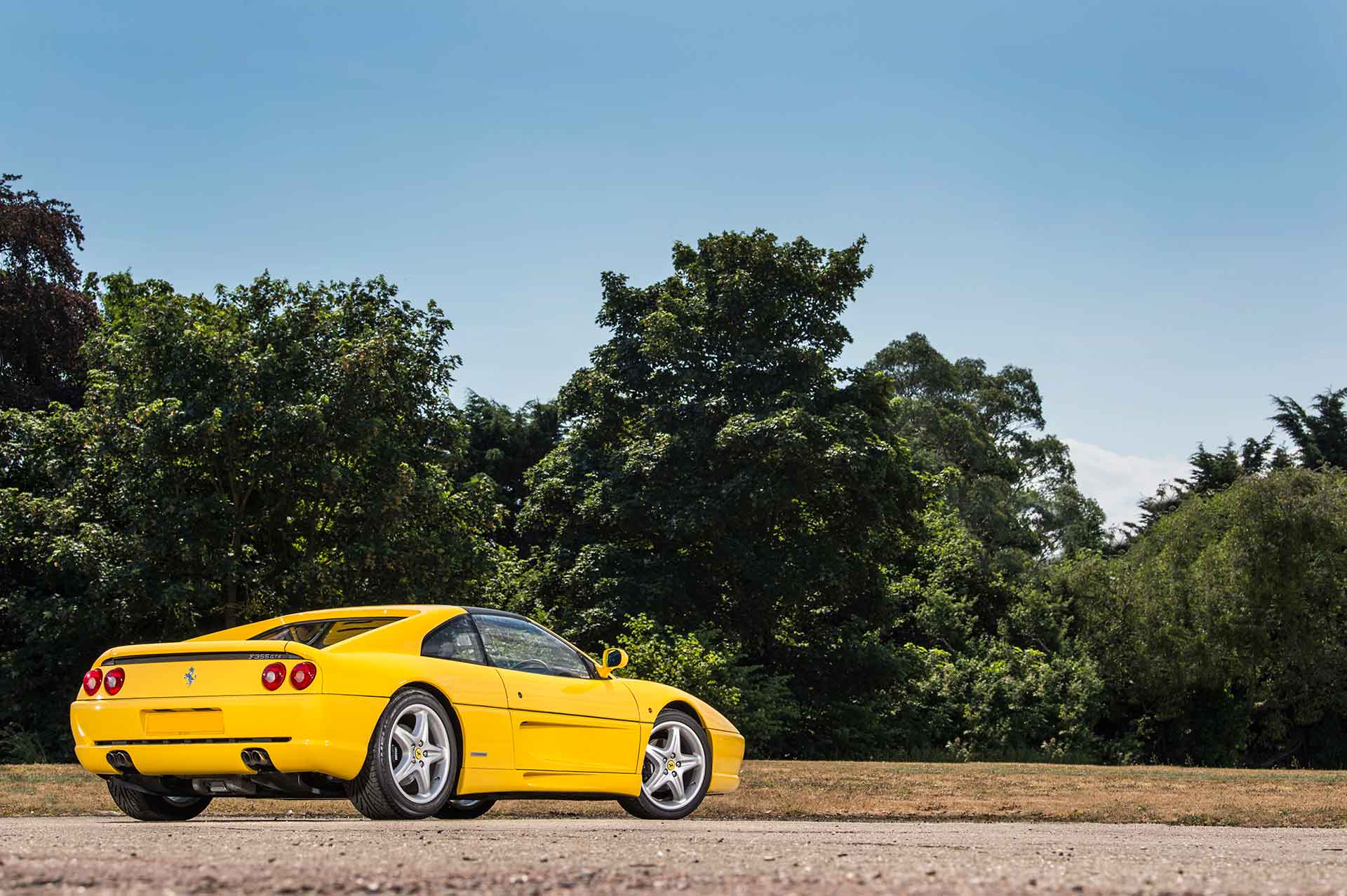 Ferrari F355 overlooking field